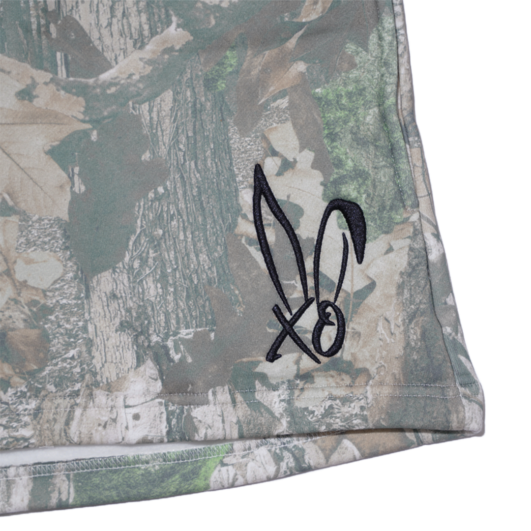 Classic real camo print fleece sweat shorts with the Bunnie Xo logo embroidered in black on the front. 