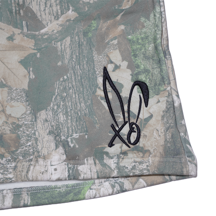 Classic real camo print fleece sweat shorts with the Bunnie Xo logo embroidered in black on the front. 