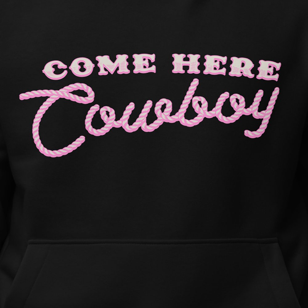 A classic black pullover hoodie with come here cowboy artwork across the front from Bunnie XO