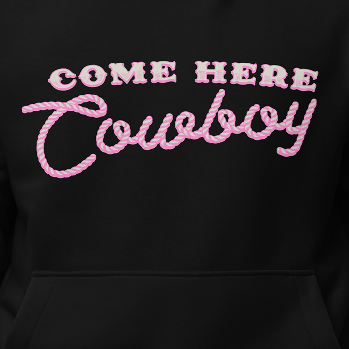 A classic black pullover hoodie with come here cowboy artwork across the front from Bunnie XO